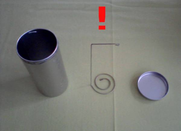 Old coffee pad tin with the original lifter made from a thick wire